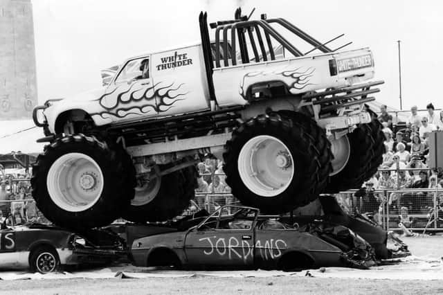 The giant White Thunder Monster Truck riding over four cars in the Southsea Show arena, 1993. The News PP5208