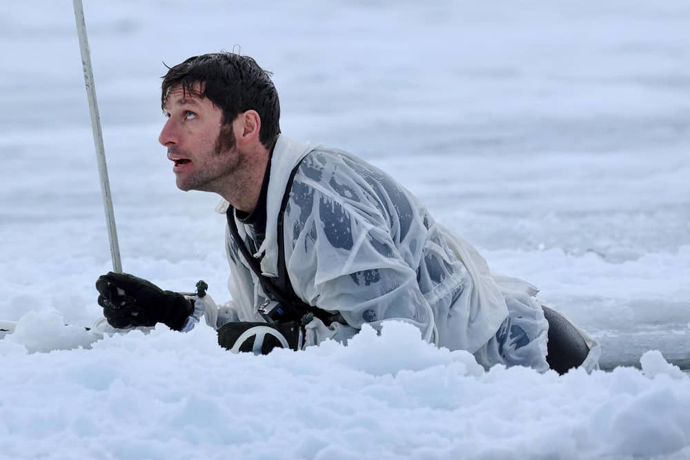 Guy Martin climbing out of a pit of ice cold water. He featured in a new series called Guy Martin: Arctic Warrior on Channel 4 (Picture: Royal Navy/Channel 4)
