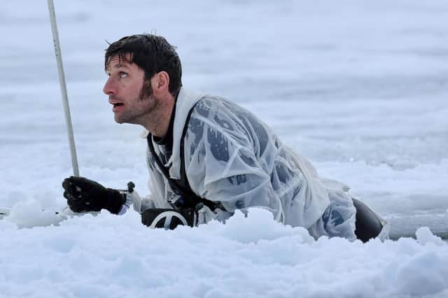 Guy Martin climbing out of a pit of ice cold water. He featured in a new series called Guy Martin: Arctic Warrior on Channel 4 (Picture: Royal Navy/Channel 4)