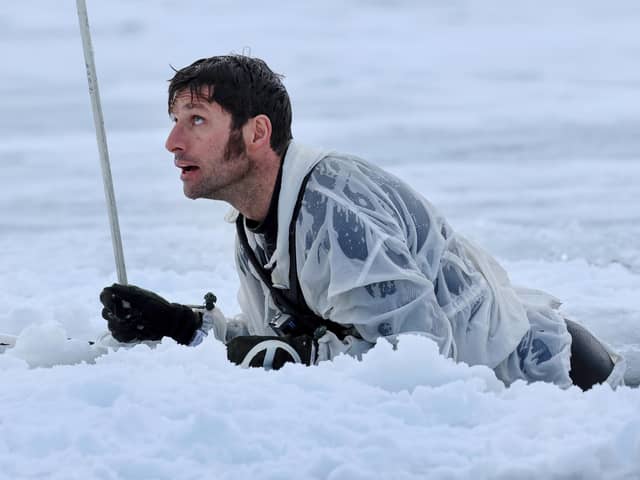 Guy Martin climbing out of a pit of ice cold water. He featured in a new series called Guy Martin: Arctic Warrior on Channel 4 (Picture: Royal Navy/Channel 4)