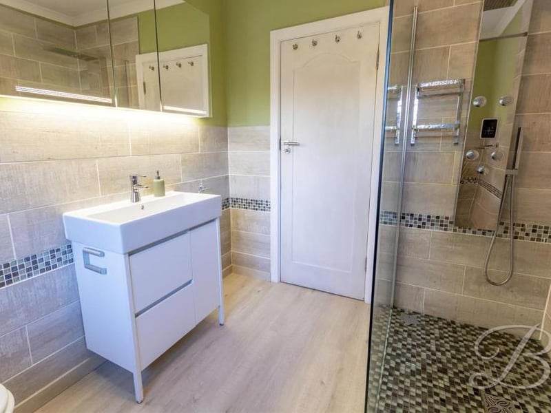 This sparkling shower-room adds to the appeal of the property. It comprises a walk-in shower, low-flush WC, pedestal wash basin, radiator and opaque window at the back.