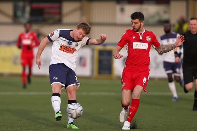 Tommy Wright, left, in action for Hawks against Hungerford Town in January - both clubs voted to carry on the South season before the league declared it null and void on February 18. Picture: Chris Moorhouse