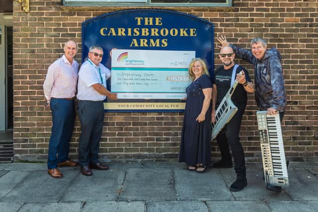 Receiving the cheque for £1094.57 raised by the band. Pictured: Daren Evans (Brighterway Charity) and Ian Hynd (Head of Brighterway Charity) with Tina Tester (Landlady of The Carisbrooke Arms), Vic Woods (HardDrive vocalist) and Kev McManus (HardDrive keyboard player and vocalist)Picture: Mike Cooter (110821)