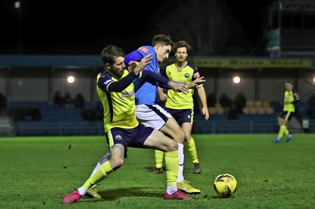 Gosport's Dan Wooden battles for possession against Wimborne. Picture: Tom Phillips