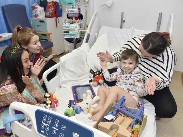 Pictured is: (l-r) Kaysha Nada as Princess Jasmine and Emma Marsh as Aladdin visit Ernest Wearn (2) and his mum Missy Read.