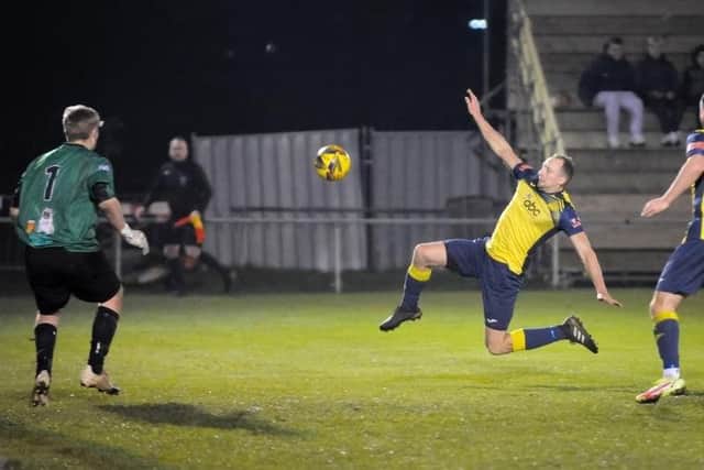 Andy Todd stretches for a cross against Clanfield. Picture: Dave Bodymore.