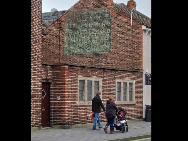 A faded sign above what is now Hashtag Hair in Winter Road, near the Westfield Road junction. Discernible words include: '94, English and Poultry.'
