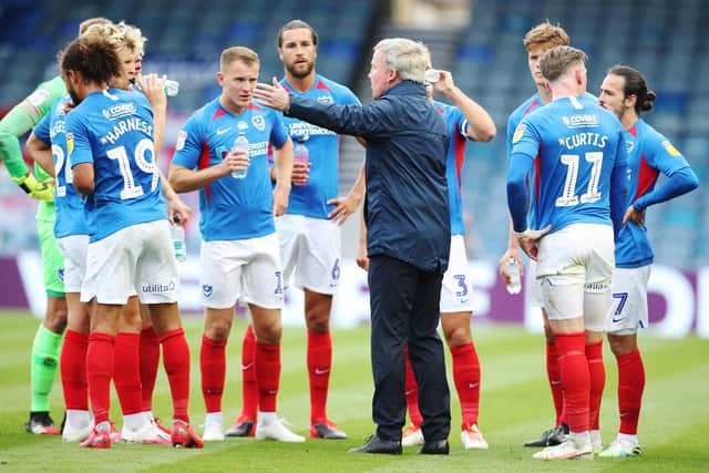 Manager Kenny Jackett talks to the Pompey players during a water break.