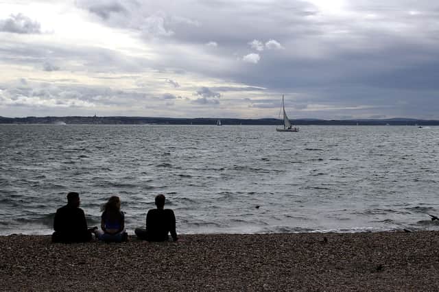 People watch as a sailing boat passes Southsea, Hampshire. PA Photo. Picture date: Monday September 7, 2020. Steve Parsons/PA Wire