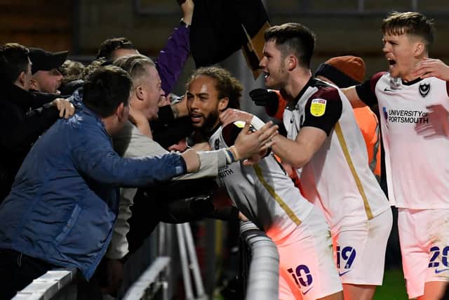 Marcus Harness celebrates with Pompey fans following his winner at Wycombe last season