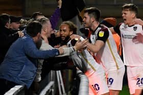 Marcus Harness celebrates with Pompey fans following his winner at Wycombe last season