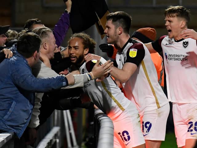 Marcus Harness celebrates with Pompey fans following his winner at Wycombe last season