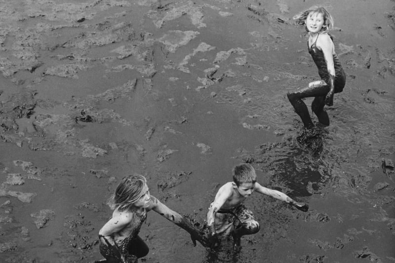 A group of children playing in the mud at low tide in Portsmouth harbour, 18th August 1962. Picture: Harry Todd/Fox Photos/Hulton Archive/Getty Images