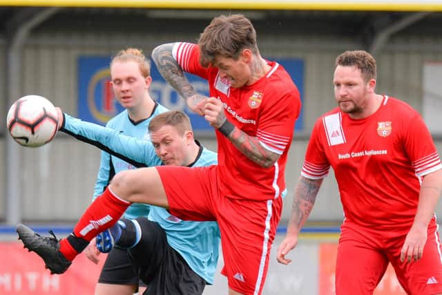 Stubbington's Aran Harvill (red) challenges for possession. Picture: Martyn White.