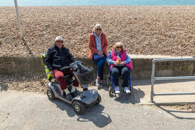 Rod Hall (80) with Jayne Harrison (74) and Joanna Hamilton (63) in front of the sea defences on Hayling Island beach. Picture: Mike Cooter (300422)