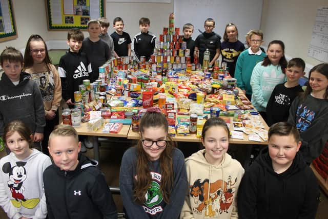 Year 6 pupils from Medina Primary School with some of the hunderds of items donated to Paulsgrove Baptist Church Foodbank.