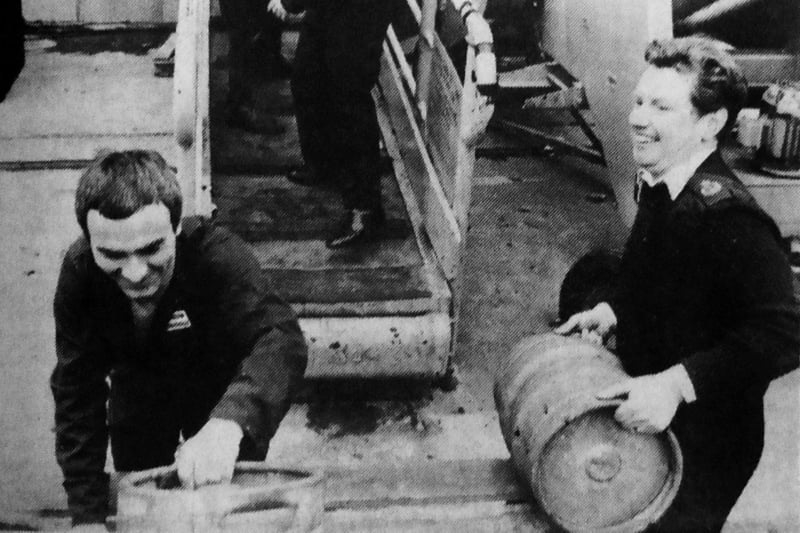 Kegs of beer are cheerfully manhandled aboard HMS Hermes in preparation for the departure for the Falkland Islands