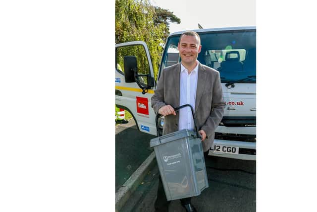 Cllr Dave Ashmore, Cabinet Member for Environment & Climate Change holding a food caddy