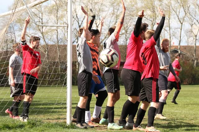 Corner or goal kick? Both Prospect Farm Rangers (red/black) and Milton Park Rangers appeal to the referee for the decision to go their way. Picture by Kevin Shipp