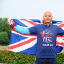 David Hughes proudly holds the Union Jack flag on The Queen's Platinum Jubilee weekend celebrations after completing his 200th parkrun event at the Fareham course Picture: Sarah Standing (040622-6264)