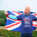 David Hughes proudly holds the Union Jack flag on The Queen's Platinum Jubilee weekend celebrations after completing his 200th parkrun event at the Fareham course Picture: Sarah Standing (040622-6264)