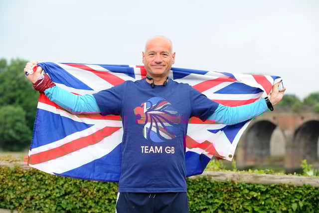 David Hughes proudly holds the Union Jack flag on The Queen's Platinum Jubilee weekend celebrations after completing his 200th parkrun event at the Fareham course Picture: Sarah Standing (040622-6264)