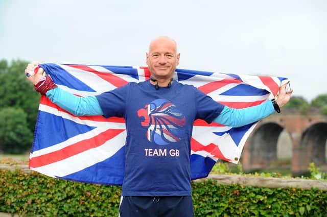 David Hughes proudly holds the Union Jack flag on The Queen's Platinum Jubilee weekend celebrations after completing his 200th parkrun event at the Fareham course Picture: Sarah Standing (040622-6264)