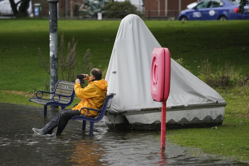 A person sitting on a bench at Canoe Lake, Southsea, Portsmouth as Storm Ciaran brings high winds and heavy rain along the south coast of England. 
Photo credit should read: Andrew Matthews/PA Wire