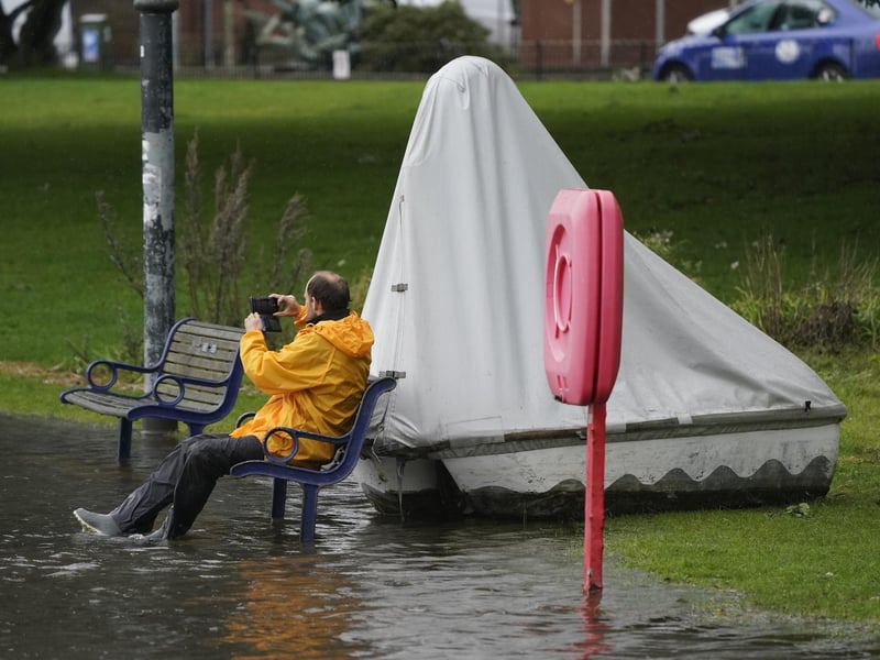 A person sitting on a bench at Canoe Lake, Southsea, Portsmouth as Storm Ciaran brings high winds and heavy rain along the south coast of England. 
Photo credit should read: Andrew Matthews/PA Wire