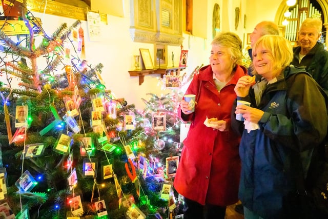 Pictured is: Susan Barker and Susan Tingley with the mulled wine and mince pies admiring one of the many trees at the event
Picture: Keith Woodland (071221-74)