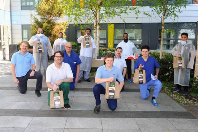 Members of the Bengali business community in Portsmouth have donated more than 100 hot meals to NHS staff at Queen Alexandra hospital. Staff from Wild Mango in Copnor and Shake & Grill in Southsea, delivered meals to QA on Monday, April 20.Pictured is: (back) Staff from Wild Mango and Shake & Grill with some of the NHS key workers from QA (front l-r) Miles Haslam, Conor Singleton, Simon Petts, Dan Yearsley, Nick Thornhill and Daniel Gudgeon.Picture: Sarah Standing (200420-7891) 