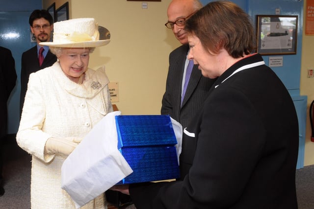 The Queen visits Portsmouth, pictured at the D-Day Museum being presented an embroidery by Dr Susan Kay-Williams and Brian Levy both of the Royal School of Needlework.

PICTURE: PAUL JACOBS (091546-29)