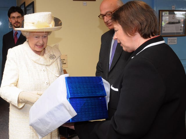 The Queen visits Portsmouth, pictured at the D-Day Museum being presented an embroidery by Dr Susan Kay-Williams and Brian Levy both of the Royal School of Needlework.

PICTURE: PAUL JACOBS (091546-29)