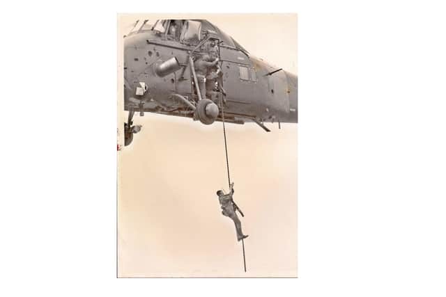 Ian Tennant, pictured rappelling from a helicopter during his basic training with the Royal Marines
