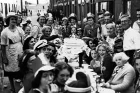 A coronation party in 1953 in Seymour Street, Buckland, with Elizabeth Johnson cutting the cake