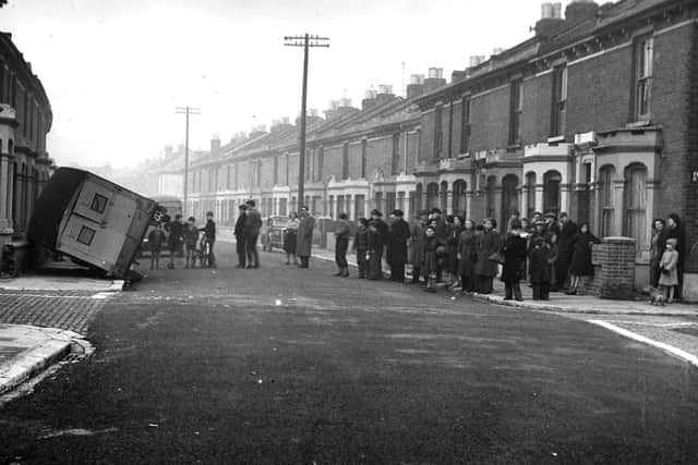 Does anyone recognise this street in Portsmouth where a Royal Mail van has ended up on its side? Picture: Colin Hull collection.