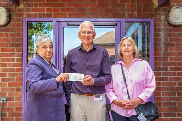 The £1,200 cheque donated to The Robert's Centre in Portsmouth. Pictured: Carole Damper MBE (65, Chief Executive of The Roberts Centre), Bill Edwards MBE (78, Chair of the Allens Road Street Party Association) and Cherry Rattue (68) - a member of the street party committee, who individually raised £380. Picture: Mike Cooter (210622)