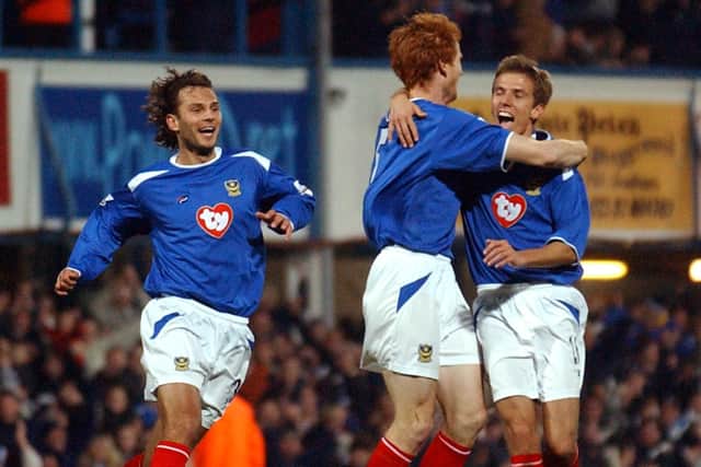 Hayden Foxe celebrates with fellow scorers Patrik Berger and Gary O'Neil during Pompey's 6-1 victory over Leeds in November 2003. Picture: Mick Young
