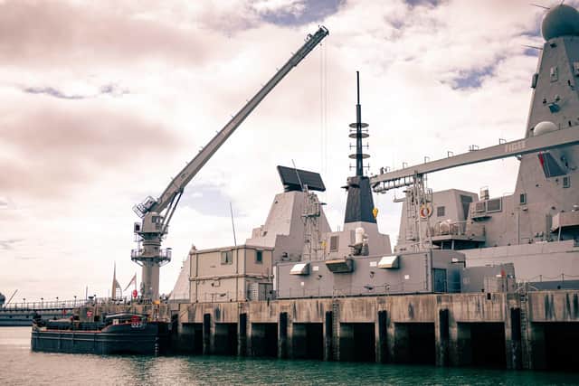 Type 45 destroyer HMS Diamond pictured alongside at the Upper Harbour Ammunition Facility in Portsmouth, where warships are rearmed safely. Photo: Royal Navy