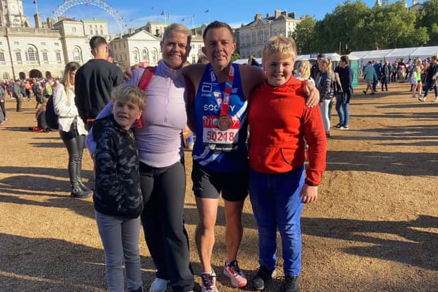 Simon Scott-Munden, 46, ran the London Marathon. Pictured with his wife Lianne and sons Theo and Blake. 