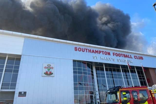 Eighteen fire engines are at the scene of the blaze, which involves four industrial units just yards away from the ground. Picture: HIWFRS