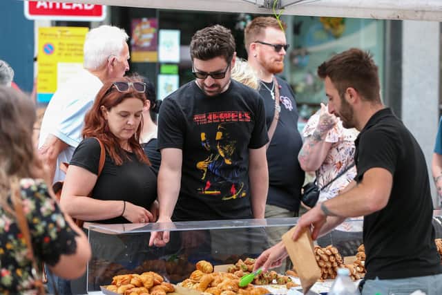 Choosing pastries. Southsea Food Festival on Palmerston, Clarendon and Osborne Roads
Picture: Chris  Moorhouse (200724-22)