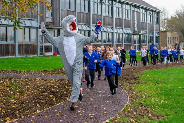 Sharps Copse Primary School is officially opening their Sharpy Shark Run track in their school field on 27 November 2020. The track was put in through funding support from Hampshire County Council (£36,000) via the sugar tax and put in by the company Scandor.Pictured:  Head Teacher, Mike Elsen leading their first run with the children on the track on 27 November 2020.Picture: Habibur Rahman