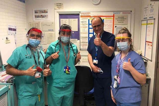 Healthcare professionals at Barts Health NHS Trust with the visors that were supplied by Havant-based Apollo Fire Detectors