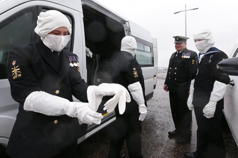 Petty officer Matthew Toon puts on his anti-flash gloves.