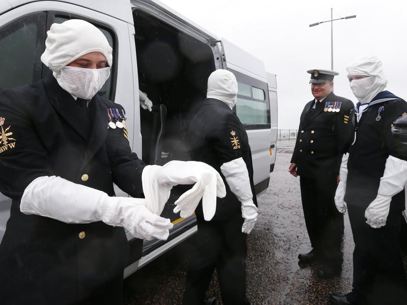 Petty officer Matthew Toon puts on his anti-flash gloves.