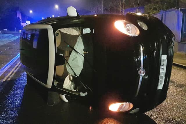 The flipped Fiat 500 which had been driven by a drunken pharmacist. Photo: Sussex Police