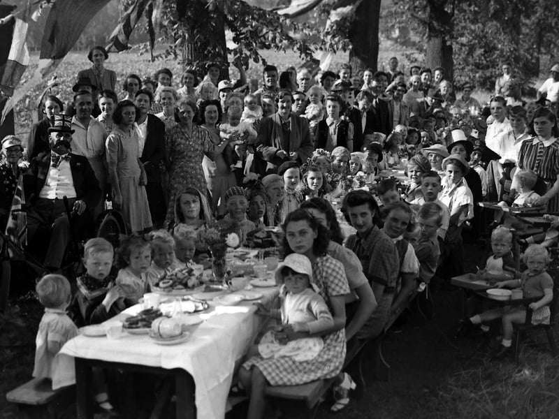 VE Day St James’s Hospital, Milton. Under shady trees to keep off the hot sun staff and their children from St Jame’s Hospital celebrate the peace with a party.