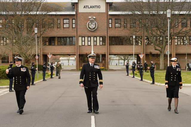 Commander Mark Walker, centre, executive officer at HMS Collingwood, pictured leaving the base for the final time with Surgeon Commander (Dentist) Julie Skelley, right ,and Reverend Mike Meachin, left. Photo: Keith Woodland