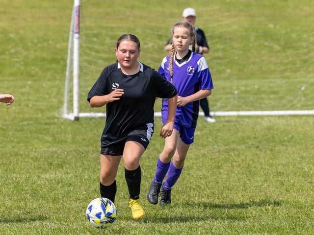 Stoneham Lionesses (purple kit) take on Bedhampton Hawks (black kit) in the Clanfield youth football tournament at Horndean Technology College. Picture: Mike Cooter